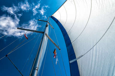 sails of a sailing yacht in the wind sailing on the oceanの写真素材