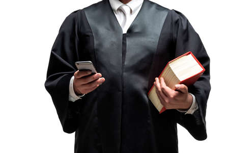 german lawyer with a classical black robe, white tie and bookの写真素材