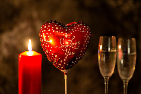 heart balloon, candle and champagne glasses on Valentine's dayの写真素材