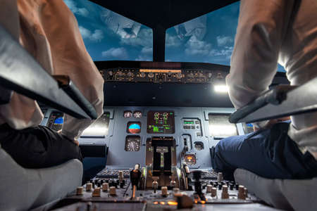 pilots in a cockpit in an airplane during flightの写真素材