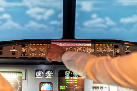 pilots in a cockpit in an airplane during flightの写真素材
