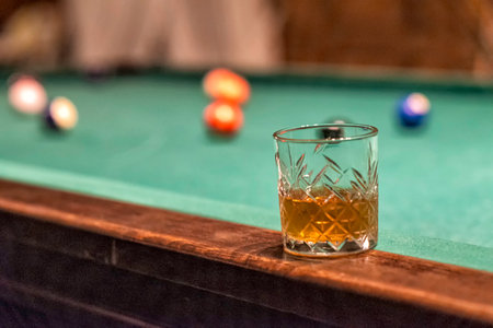 Glass of Rum on a billiard table in an old castle with billiard balls and billiard cuesの写真素材