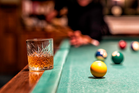 Glass of Rum on a billiard table in an old castle with billiard balls and billiard cuesの写真素材