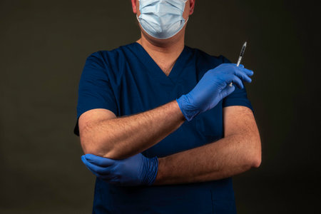 Doctor with blue clothing and a stethoscope in a hospitalの写真素材