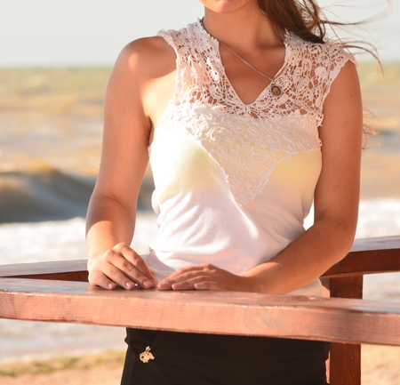Young beautiful woman poses for a girl on a sea summer photo shootの写真素材
