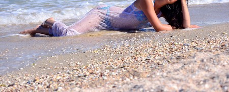 Young beautiful woman poses for a girl on a sea summer photo shootの写真素材