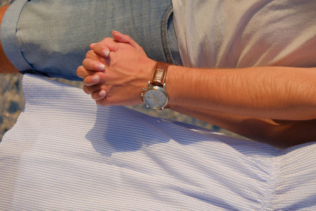 Man and woman holding hands on the background of the sea. Close-up.の写真素材