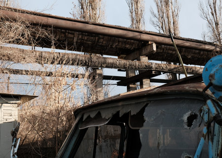 Abandoned industrial area. Old rusty truck with broken roof.の写真素材