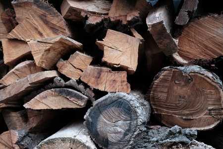 Firewood stacked in a pile, close-up of chopped firewood