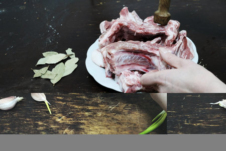 Raw pork ribs with garlic and bay leaf on wooden table. Selective focus.