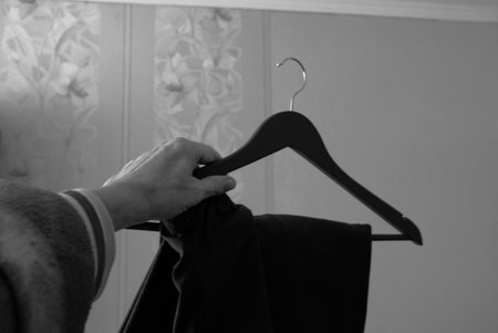 Man holding a hanger in his hand 1の写真素材