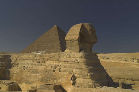 Sphinx with the great pyramid behind it Giza Cairo Egypt.