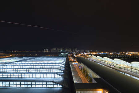 Hong Kong, China - March 25th 2018 : Hong Kong International Airport (HKIA) on Chek Lap Kok island after sunset with aircraft light trailsのeditorial素材