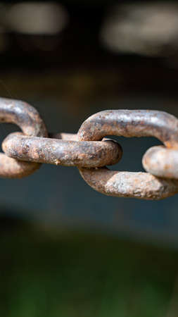 rusty chain in horizontal closeup isolated with unfocused background
