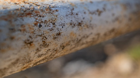 Close up of a rusty metal fence with rust on it. Selective focus.