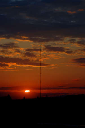 sunset with a high towerの写真素材