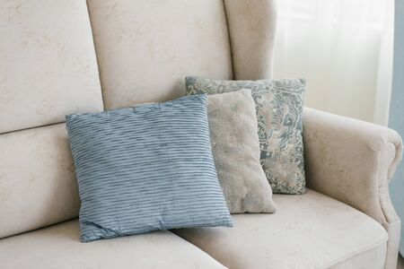 Blue and gray pillows on the sofa in the living roomの写真素材