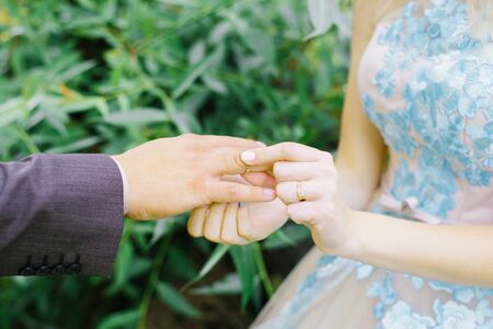 the bride wore a ring for the groom. newlyweds with rings on their fingers on their wedding day.wedding ceremony close-up.の写真素材