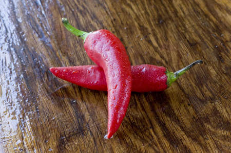 Two red peppers on  the preparation table