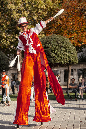 Istanbul, Turkey, SEPTEMBER 28 2012: It is a entertainment festival in a street of Istanbul stilts walker man in red juggling smilingのeditorial素材