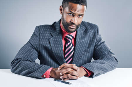 A young African American businessman signing a contract.の写真素材