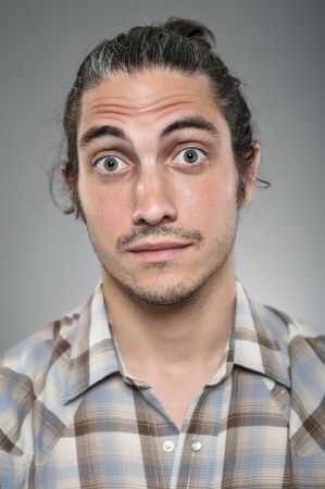 A Caucasian man in his 30's with a look of wide eyed surprise.の写真素材