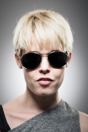 A beautiful young Caucasian woman in her twenties wearing aviator sunglasses.の写真素材