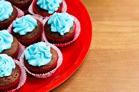 A plate of chocolate birthday cupcakes.の写真素材