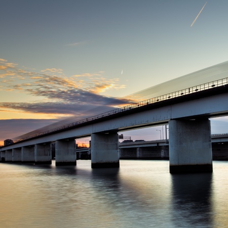 A speeding Metro rail train going over an elevated railway over the Potomac River in Washington DC.