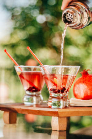 Pomegranate martinis served in an outdoor setting の写真素材