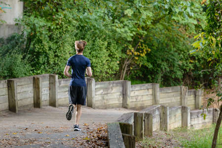 Young man running in the parkの写真素材