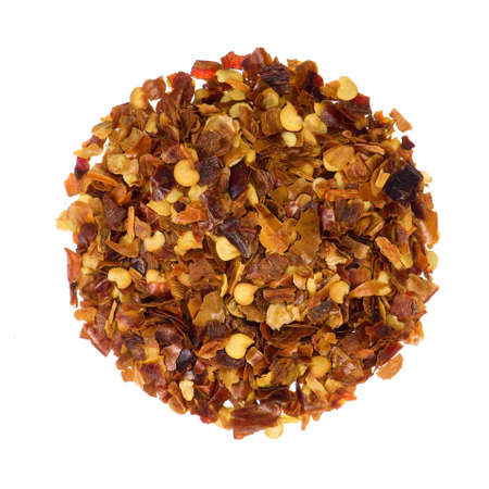 Closeup overview of crushed red pepper isolated on whiteの写真素材