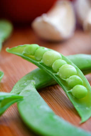 Closeup of fresh peas with tomato and garlicの写真素材