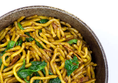 Stir-fried noodle with bacon and spinachの写真素材