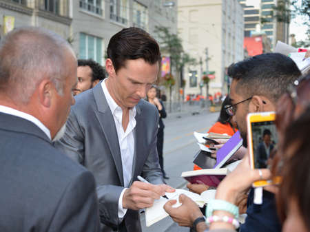 TORONTO - SEPTEMBER 6: Actor Benedict Cumberbatch signs autographs at the Toronto International Film Festival for his new film 12 Years a Slave on September 6, 2013.のeditorial素材