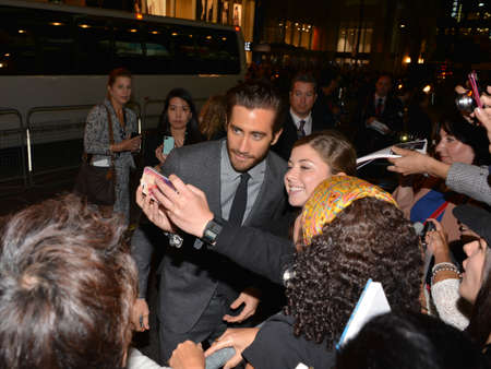 TORONTO - SEPTEMBER 6: Actor Jake Gyllenhaal takes a selfie with fans at the Toronto International Film Festival for his new film Prisoners on September 6, 2013.のeditorial素材