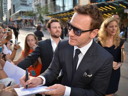 TORONTO - SEPTEMBER 6: Actor Michael Fassbender signs autograph at the Toronto International Film Festival for his new film 12 Years a Slave on September 6, 2013.のeditorial素材