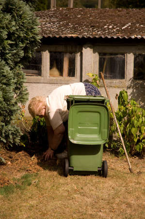 Senior woman with a passion for gardening working in her lovely garden