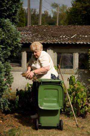 Senior woman with a passion for gardening working in her lovely garden