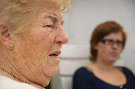 senior woman chatting outside with her redhead granddaughterの写真素材