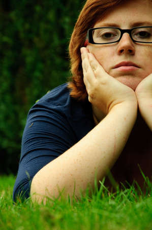 Beautiful young woman relaxing in the grassの写真素材