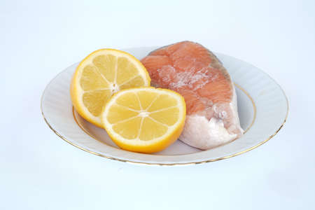 lemon and salmon on porcelain plate