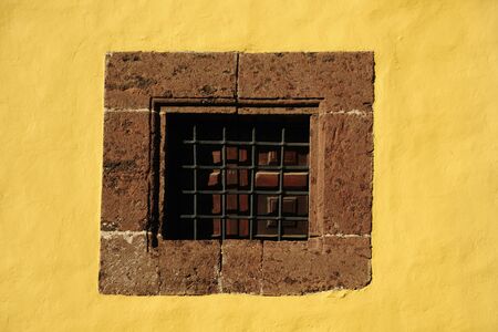 old window on yellow wallの写真素材