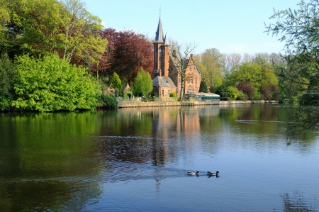 Old house on the channel in Bruges, Belgium, in a sunny day のeditorial素材