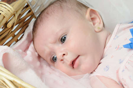 Adorable baby boy in wicker basket