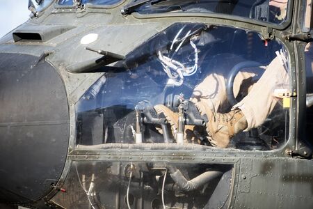 Close-up of the pilot's feet on the controls of the helicopter