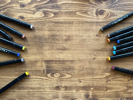 Background. Wooden table with scattered markers