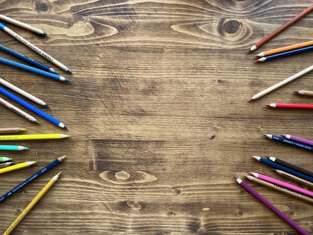Background. Wooden table with multicolor pencilsの写真素材
