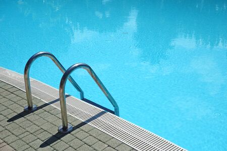Ladder in a crystal clear blue swimming poolの写真素材