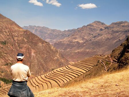 Man tourist looking at Pisac Inca Ruins Site Incan Peru Sacred Valleyの写真素材